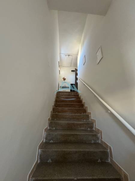 Eine Treppe mit weißen Wänden, die zu einer Wohnung in einer 3-Zimmer-Wohnung führt.