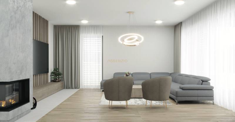 Wohnzimmer in einem Einfamilienhaus mit Kamin, moderner Beleuchtung und grauem Sofa.