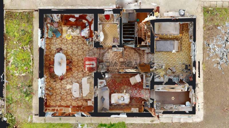 Grundriss eines Einfamilienhauses mit Wohnzimmer, Schlafzimmer und Küche.