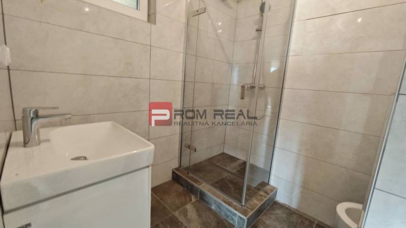 Badezimmer in einer 4-Zimmer-Wohnung mit Duschkabine und Waschbecken.