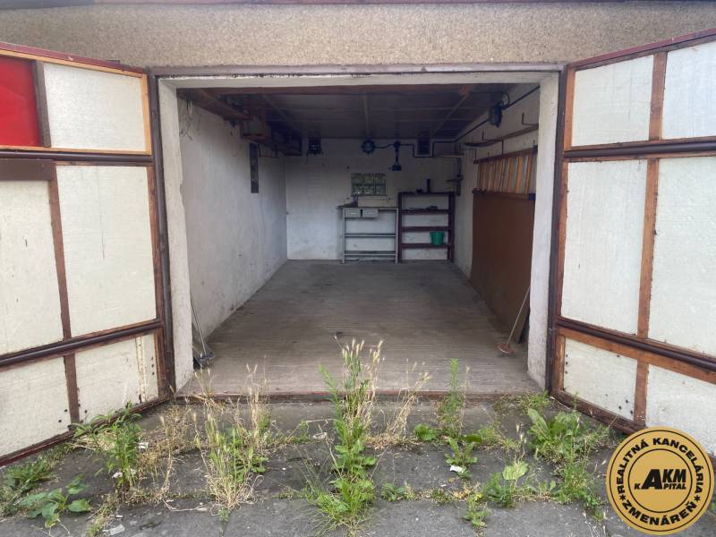 Eine offene Garage mit altem Interieur und Pflanzen vor der Garage in Zvolen.