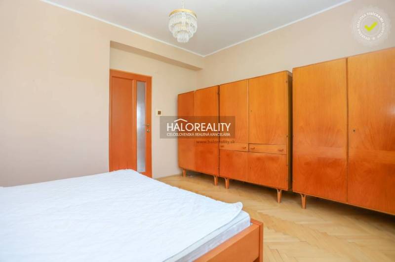 Schlafzimmer in einer 3-Zimmer-Wohnung mit Einbauschrank und Holzmöbeln.