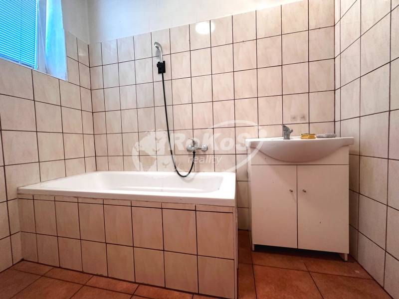 Badezimmer mit Badewanne und Waschbecken in einer 3-Zimmer-Wohnung.