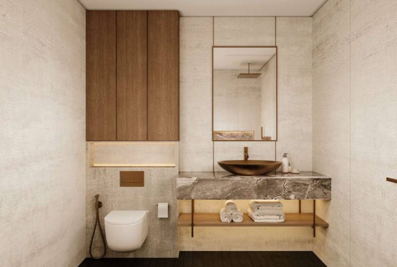 Minimalistisches Badezimmer in einem Einfamilienhaus mit steinernem Waschbecken und Toilette in neutralen Tönen.