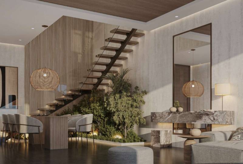 Innenraum eines Einfamilienhauses mit Treppe, Esstisch und Designerleuchten.