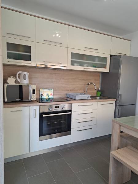 Küche in einer 3-Zimmer-Wohnung mit hellen Schränken und Edelstahlgeräten.
