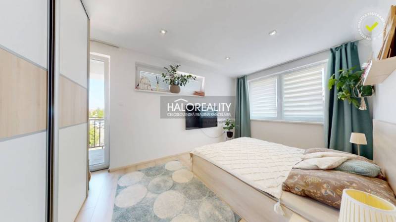 Helles Schlafzimmer mit großem Bett und Balkontüren in einer 3-Zimmer-Wohnung.
