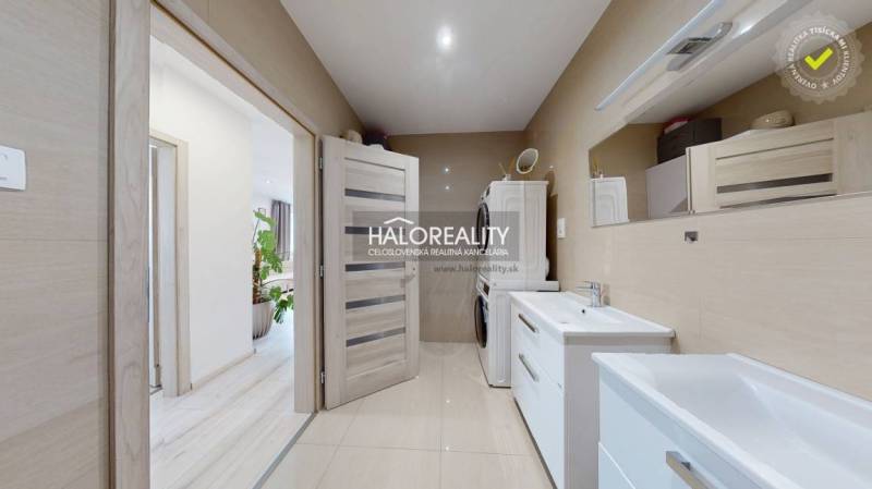 Badezimmer in einer 3-Zimmer-Wohnung mit zwei Waschbecken und einer Waschmaschine.
