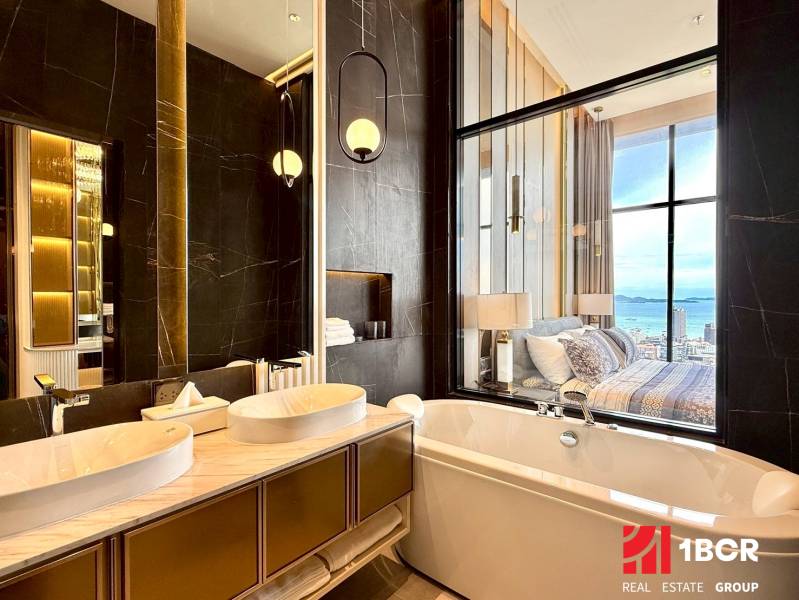 Luxuriöses Badezimmer in einer 4-Zimmer-Wohnung mit Blick vom Bett auf das Meer.