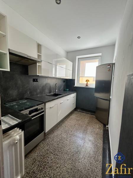 Küche in einer 3-Zimmer-Wohnung mit Spüle, Herd und Kühlschrank.