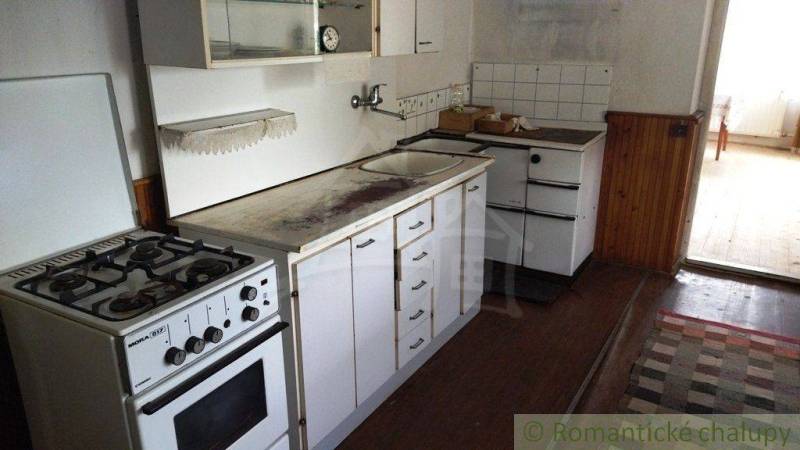 Küche in einem Einfamilienhaus mit Gasherd und Aufbewahrungsschränken.