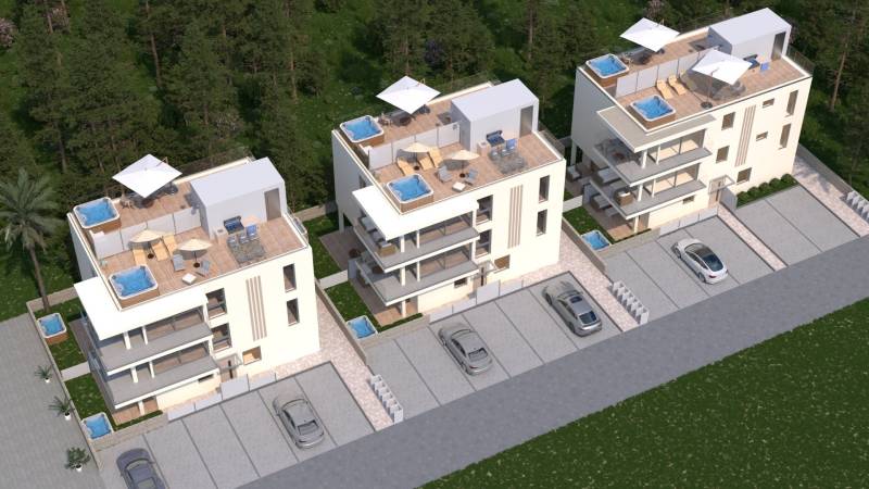 Drei moderne Apartmentgebäude mit Terrassen, Jacuzzi und Parkplätzen, umgeben von Grünflächen.