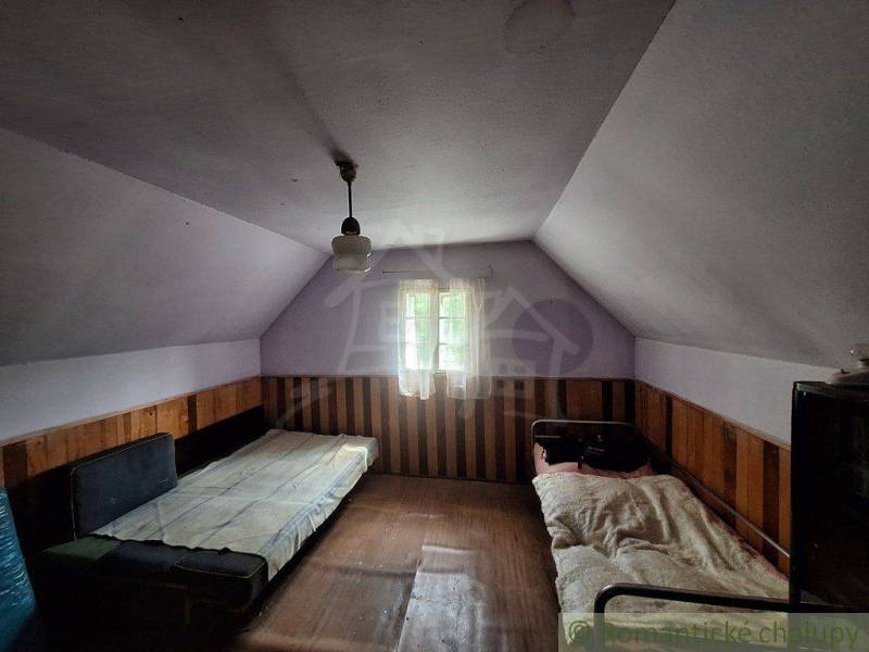 Das Innere der Hütte mit zwei Betten und Holzverkleidung, gedämpftes Licht.