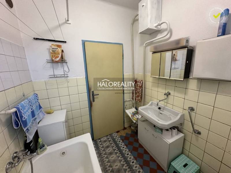 Badezimmer in einem Einfamilienhaus mit Waschbecken, Badewanne und Stauraum.