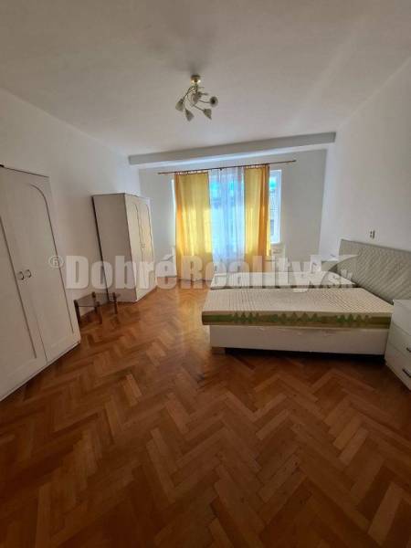 Helles Zimmer mit Einbauschrank und Bett in einer 3-Zimmer-Wohnung mit Parkett.