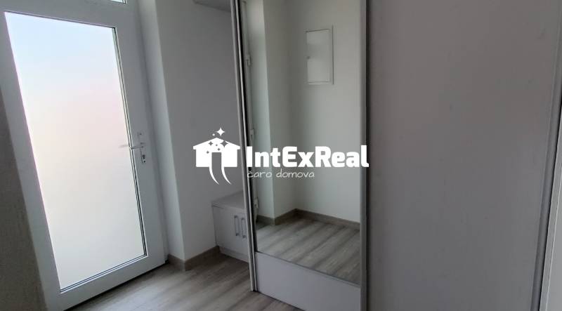 Der Flur einer 2-Zimmer-Wohnung mit weißen Türen und einem Einbauschrank.