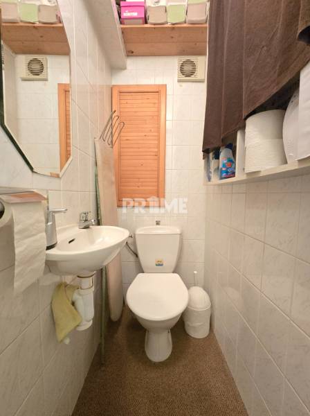 Toilette in einer 3-Zimmer-Wohnung mit Waschbecken und Stauraum.