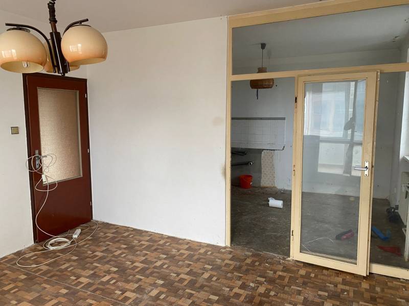 Innenraum einer 3-Zimmer-Wohnung mit Parkettboden und Glastüren.