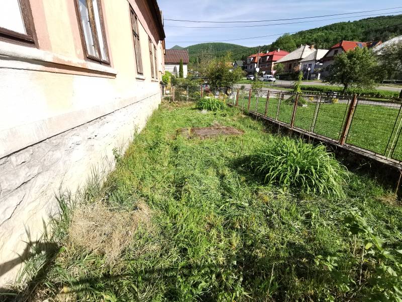 Der Garten des Einfamilienhauses in Nitrianske Sučany mit Blick auf die Straße und die Hügel.