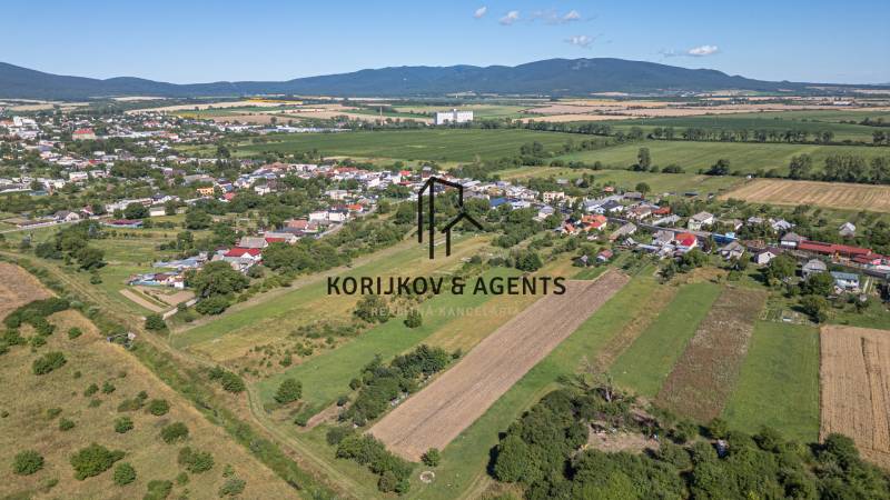 Panoramablick auf Sečovce mit weitläufigen Wohngebieten und umliegenden Feldern.