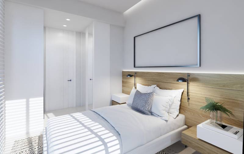Schlafzimmer in einer 3-Zimmer-Wohnung mit Bett, Nachttischen und Einbauschrank.