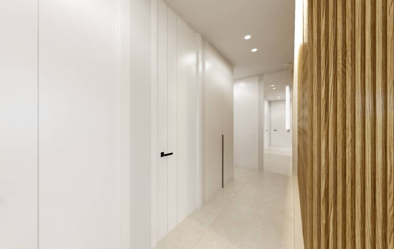 Ein minimalistischer Flur in einer 3-Zimmer-Wohnung mit weißen Wänden und Holzverkleidung.
