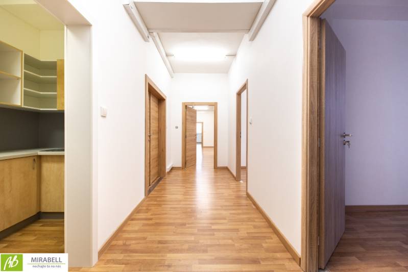 Flur mit Holzboden und Bürotüren.