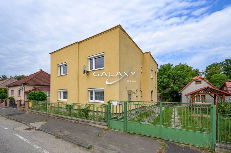 Gelbes Einfamilienhaus mit Garage und Garten in der Stadt Vidiná.