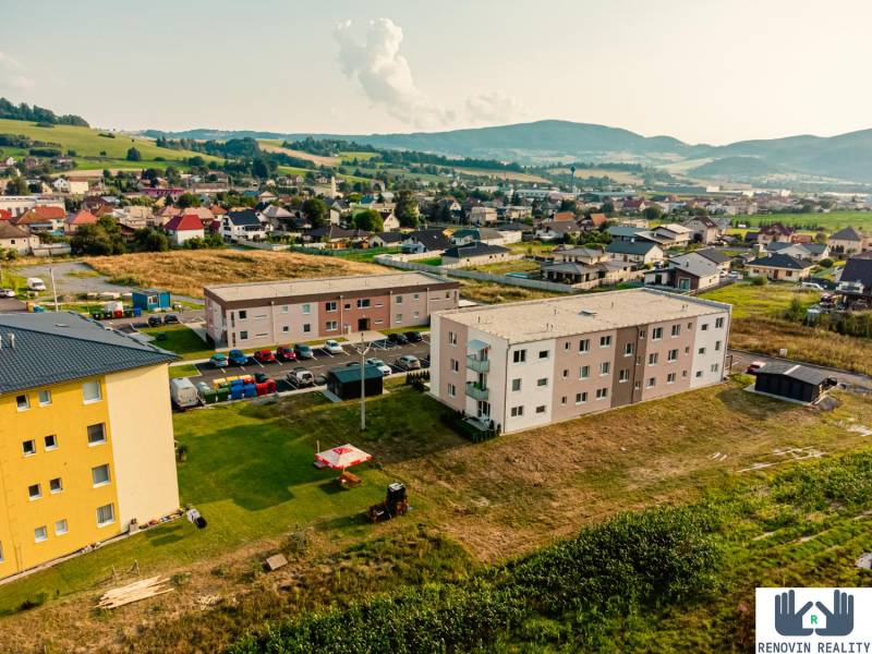Wohnungsbau in Kriváň, umgeben von Landschaft und Einfamilienhäusern.