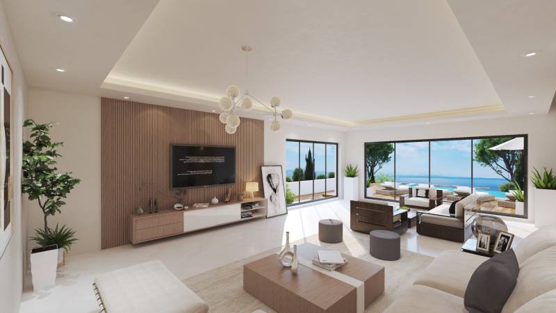 Wohnzimmer in einer Villa mit Blick auf den Ozean, großen Fenstern und bequemen Sitzgelegenheiten.
