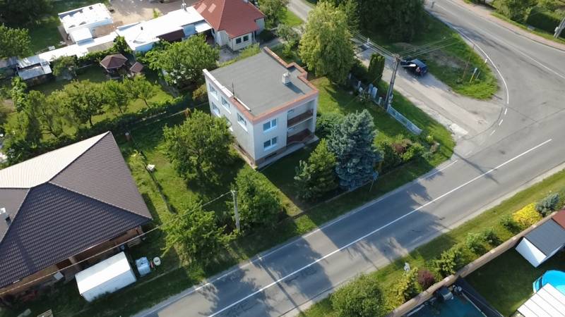 Ein Einfamilienhaus in Rakoľuby in Nové Mesto nad Váhom, umgeben von Grünflächen und einer Straße.