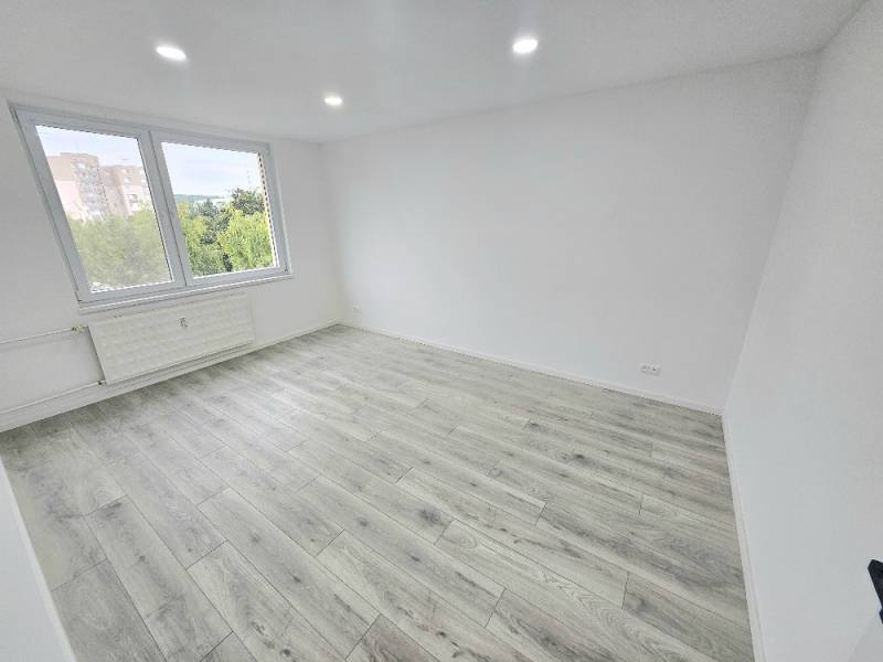 Helles Zimmer, Laminatboden, großes Fenster, 3-Zimmer-Wohnung.