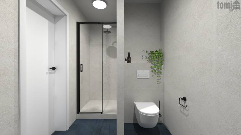 Badezimmer in einer 2-Zimmer-Wohnung mit Dusche, Toilette und Pflanze an der Wand.