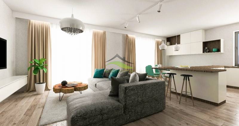 Wohnzimmer eines Einfamilienhauses mit bequemer Couch, Kücheninsel und Holzelementen.