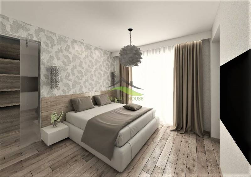 Ein Schlafzimmer in einem Einfamilienhaus mit Holzboden und gemusterten Tapeten.