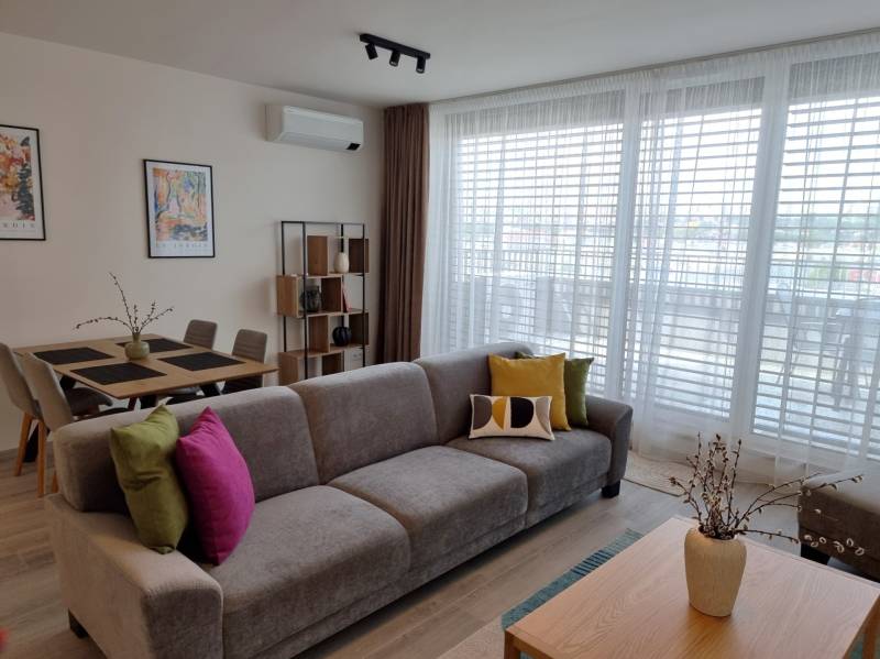 Wohnzimmer mit Sofa, Esstisch und Regalen in einer 3-Zimmer-Wohnung.