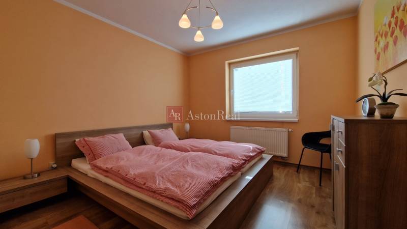 Schlafzimmer mit Doppelbett und Holzmöbeln im Ferienapartment.