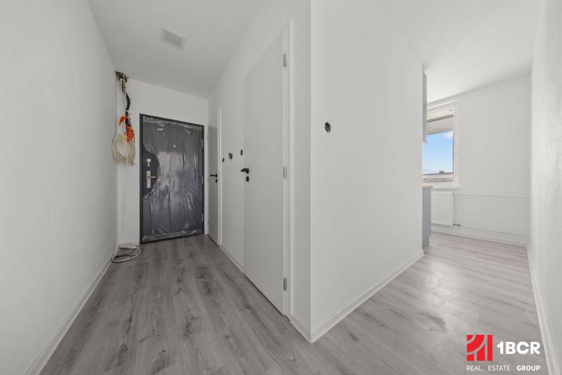Eingangsflur in einer 2-Zimmer-Wohnung mit Vinylboden und Kunststofftüren.
