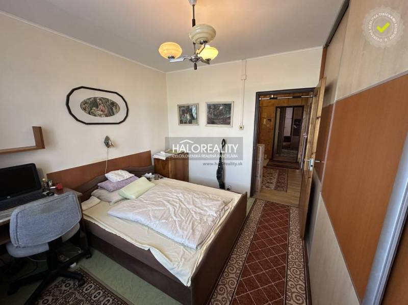 Schlafzimmer in einer 3-Zimmer-Wohnung mit Einbauschrank, Computertisch und Wanddekoration.