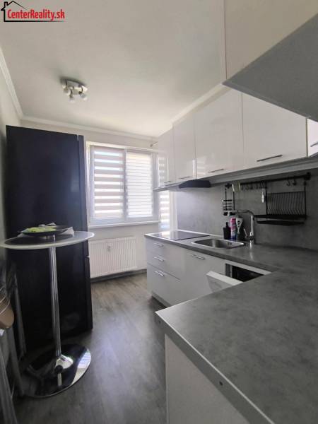 Küche in einer 2-Zimmer-Wohnung mit eingebauten Geräten und heller Einrichtung.