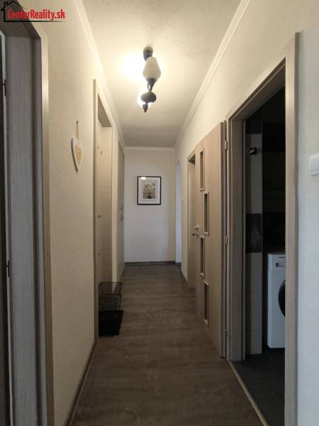 Der Flur in einer 2-Zimmer-Wohnung mit hellem Boden und einfacher Beleuchtung.