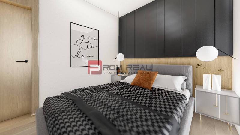 Schlafzimmer in einer 2-Zimmer-Wohnung mit einem bequemen Bett und einer dekorativen Wand.