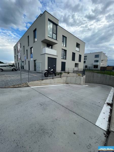 Dreistöckiges Wohnhaus in der Dúhová-Straße in Slovenský Grob mit einem Parkplatz.