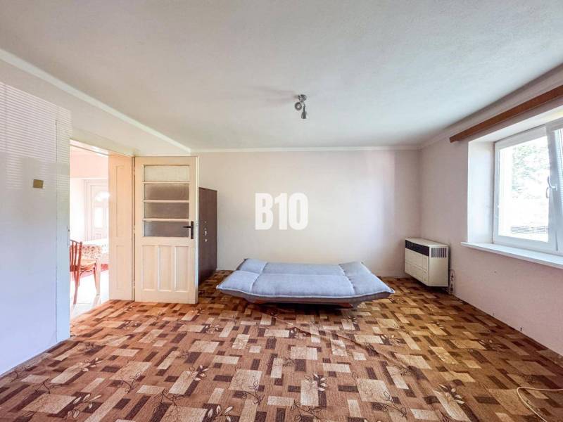 Wohnzimmer in einem Einfamilienhaus mit Holzboden und Sofa.