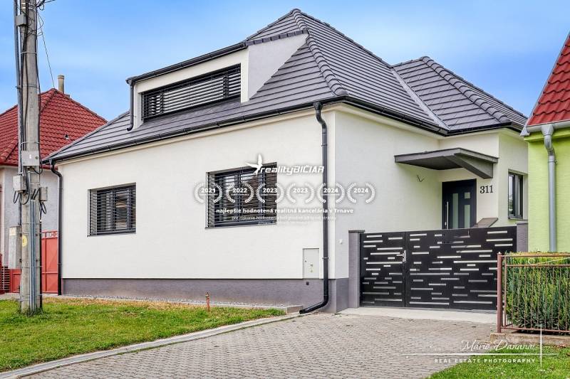 Ein Einfamilienhaus in der Orechová-Straße in Jaslovské Bohunice mit modernem Dach und Zaun.