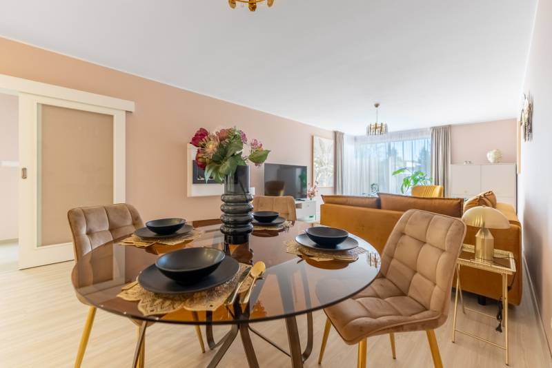 Ein Tisch mit Tischsets im Esszimmer, im Hintergrund das Wohnzimmer eines Einfamilienhauses.