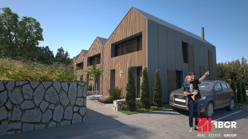 Einfamilienhäuser in Turecká mit Holzdekor, Steinzaun und geparktes Auto.