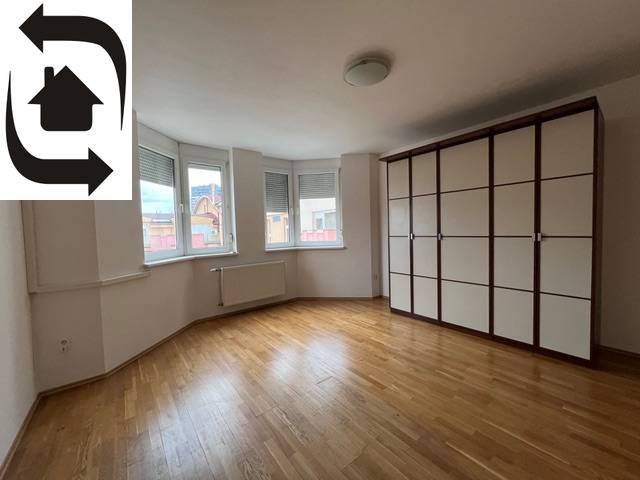 Geräumiges Zimmer mit Holzboden und Einbauschrank in einer 3-Zimmer-Wohnung.