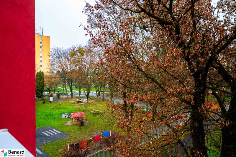 Blick auf den Kinderspielplatz und die Bäume von einer 2-Zimmer-Wohnung in der Ľudová-Straße in Košice.