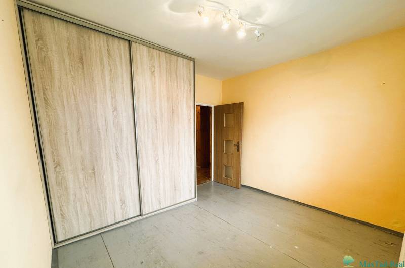 Das Zimmer enthält einen Einbauschrank und einen Boden mit Holzdekor in einer 3-Zimmer-Wohnung.